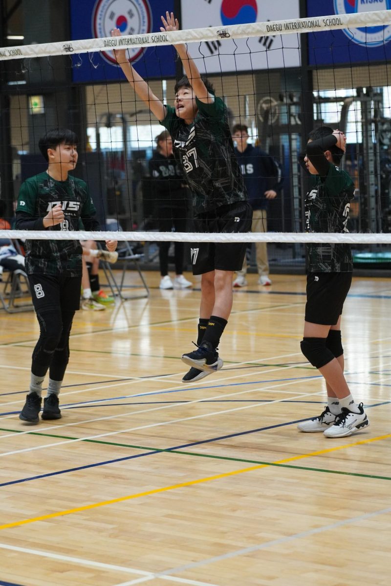 Outside hitter Jacob Lee (37) jumps high to practice his blocking techniques. As a sixth grader, he awaits future volleyball seasons and prepares to step up his game.