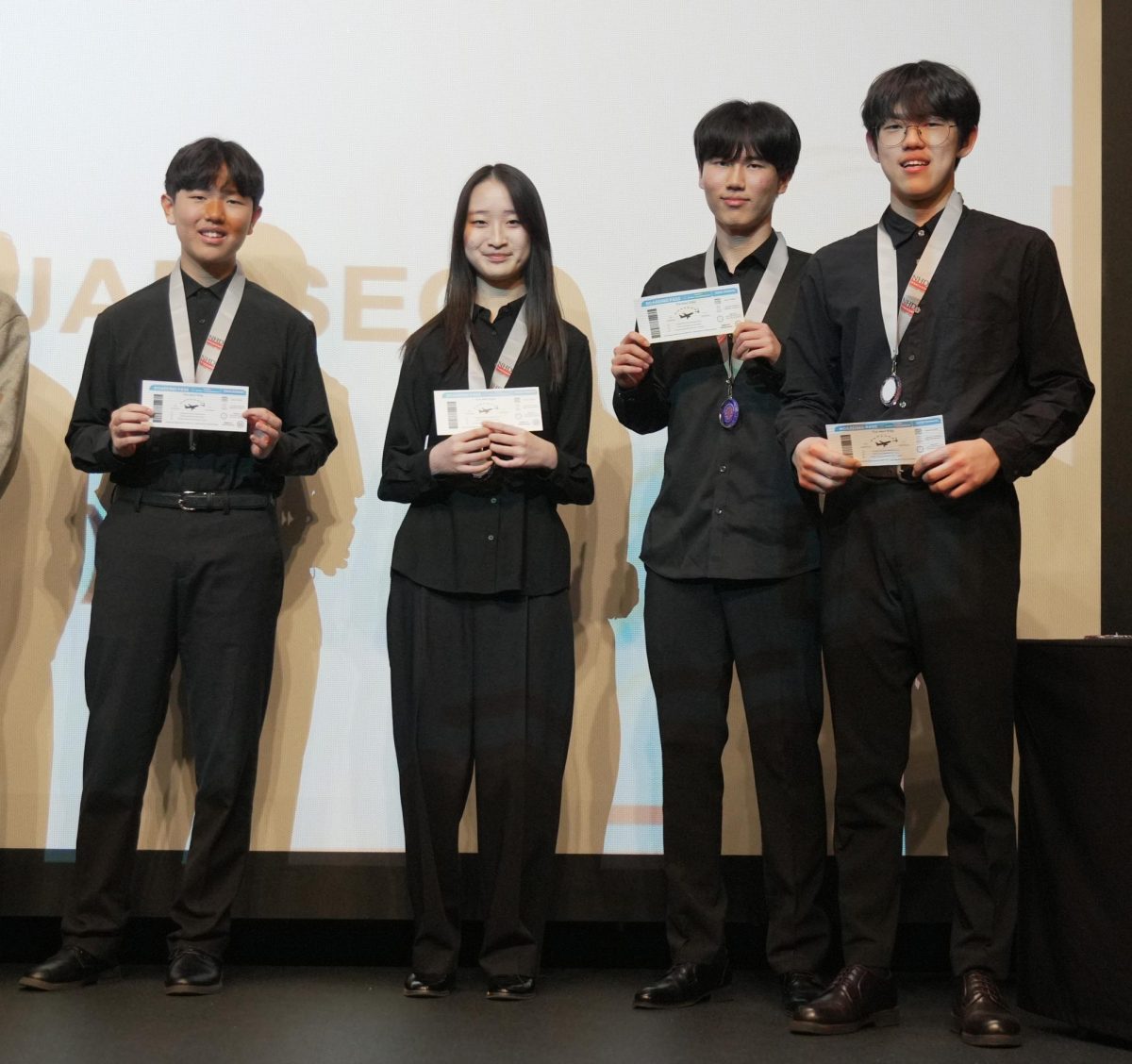 Sophomores Alex Seo and Elena Lee and freshmen Charlie Park and Kevin Ahn stand proudly after their victory in the Senior Group Website finals. In June, they will go on to represent DIS at the national competition. 