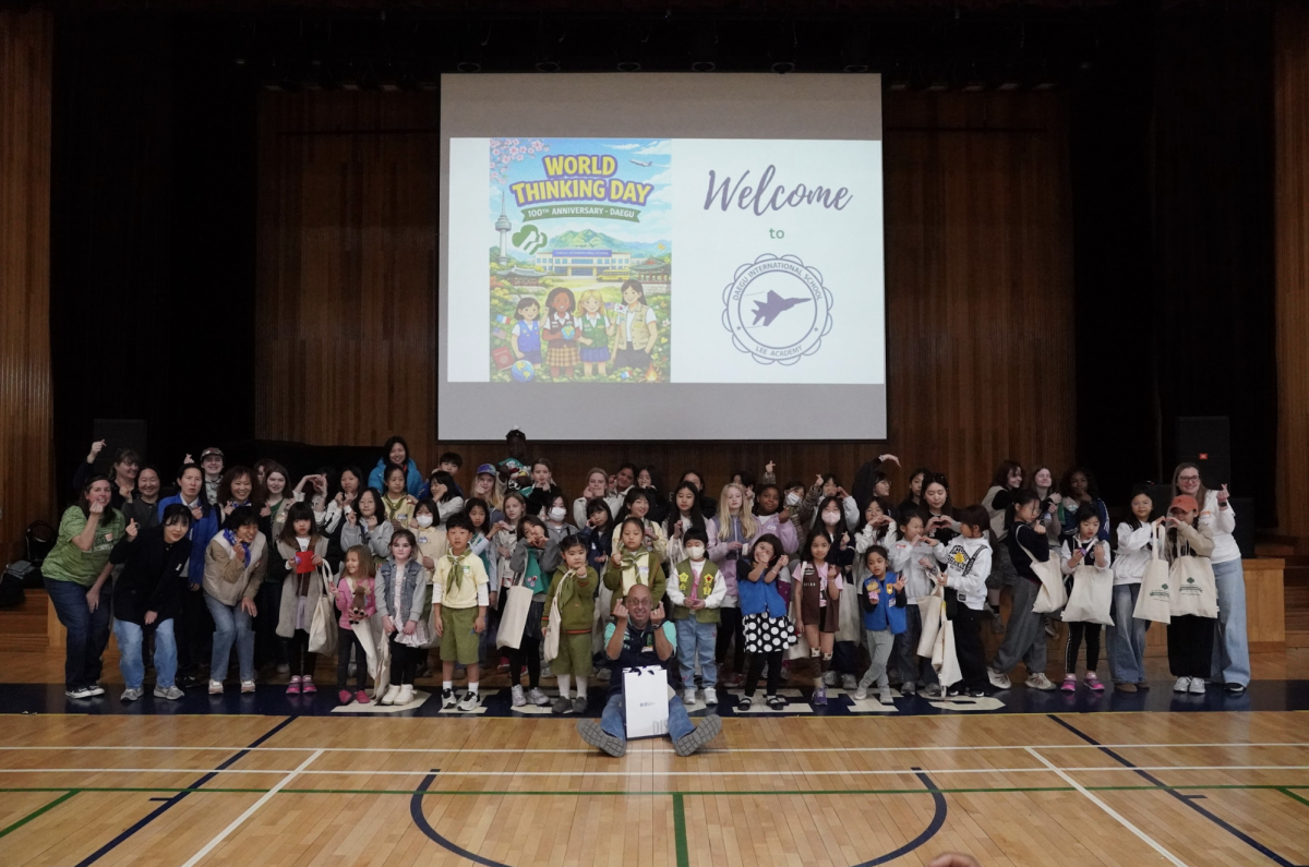DIS Girl Scout Troop hosts World Thinking Day, celebrating its 100th anniversary in the Jetnasium. Smiles linger in the gym long after the event.
