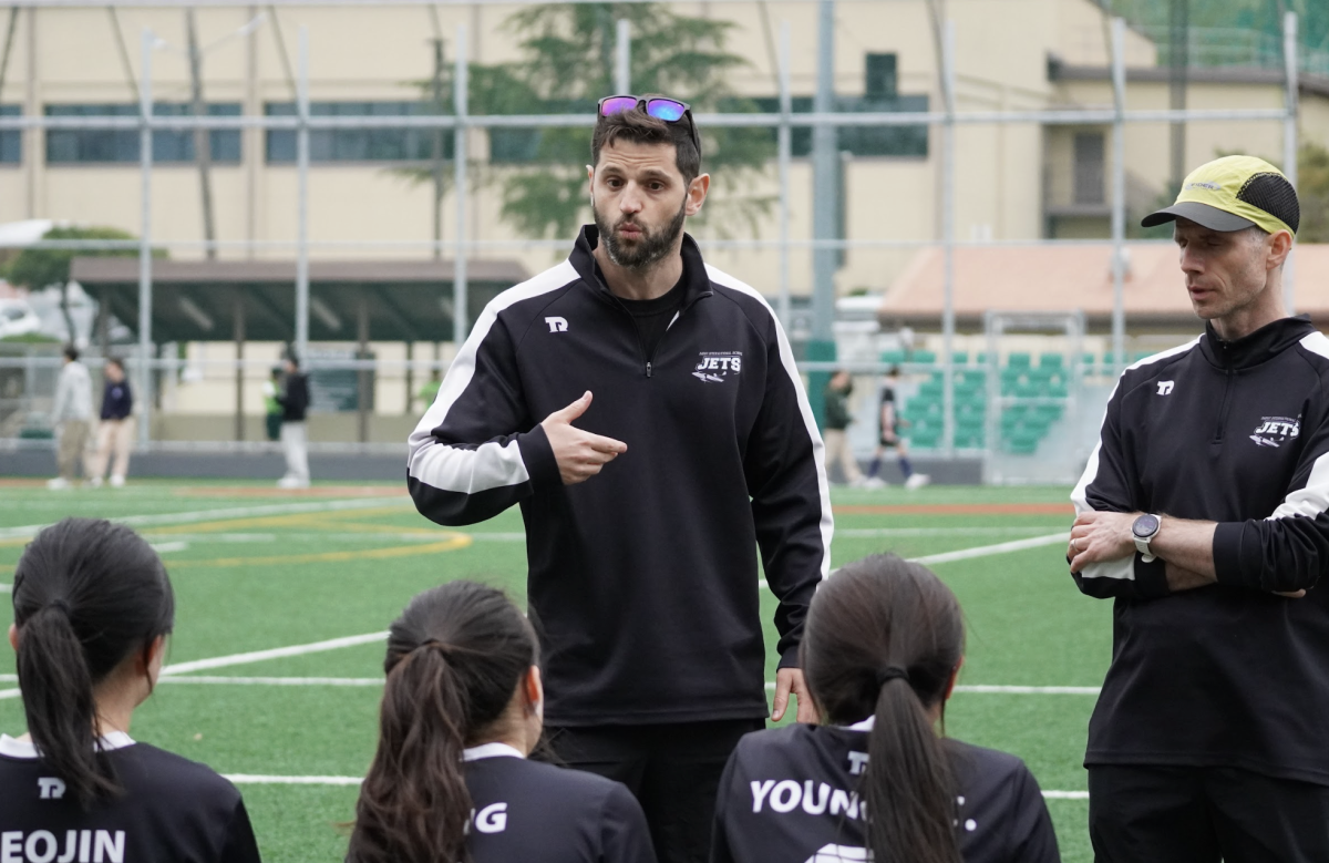 Moments before kickoff, Coach Faille gathers his players for final reminders of key techniques and tips on the field. In his final season, he looks to cap his tenure with both strong results and lasting memories. 