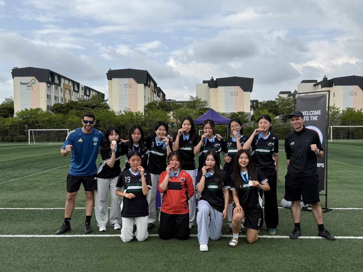 The high school girls' soccer team celebrates a third-place finish, proudly displaying their bronze medals after battling through a series of intense tournament matches. Their relentless training and teamwork culminate in a podium finish, building momentum heading into SKAIS.