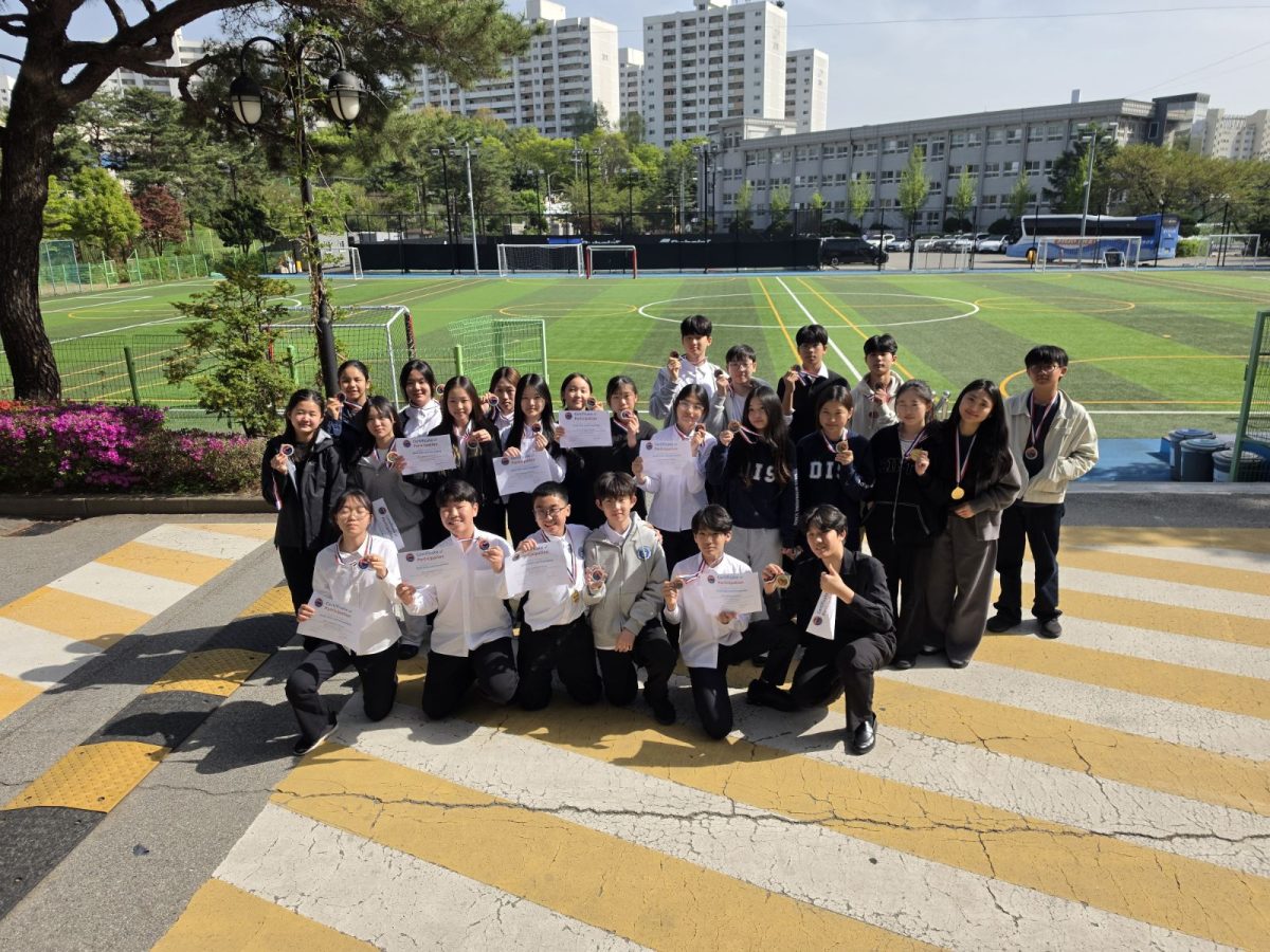 Middle school musicians celebrate their achievement, holding medals and certificates after earning top ratings on the live ticker. Their energy and sense of accomplishment reflect the dedication and effort behind their performance. Photo courtesy of Mr. Hutchings.