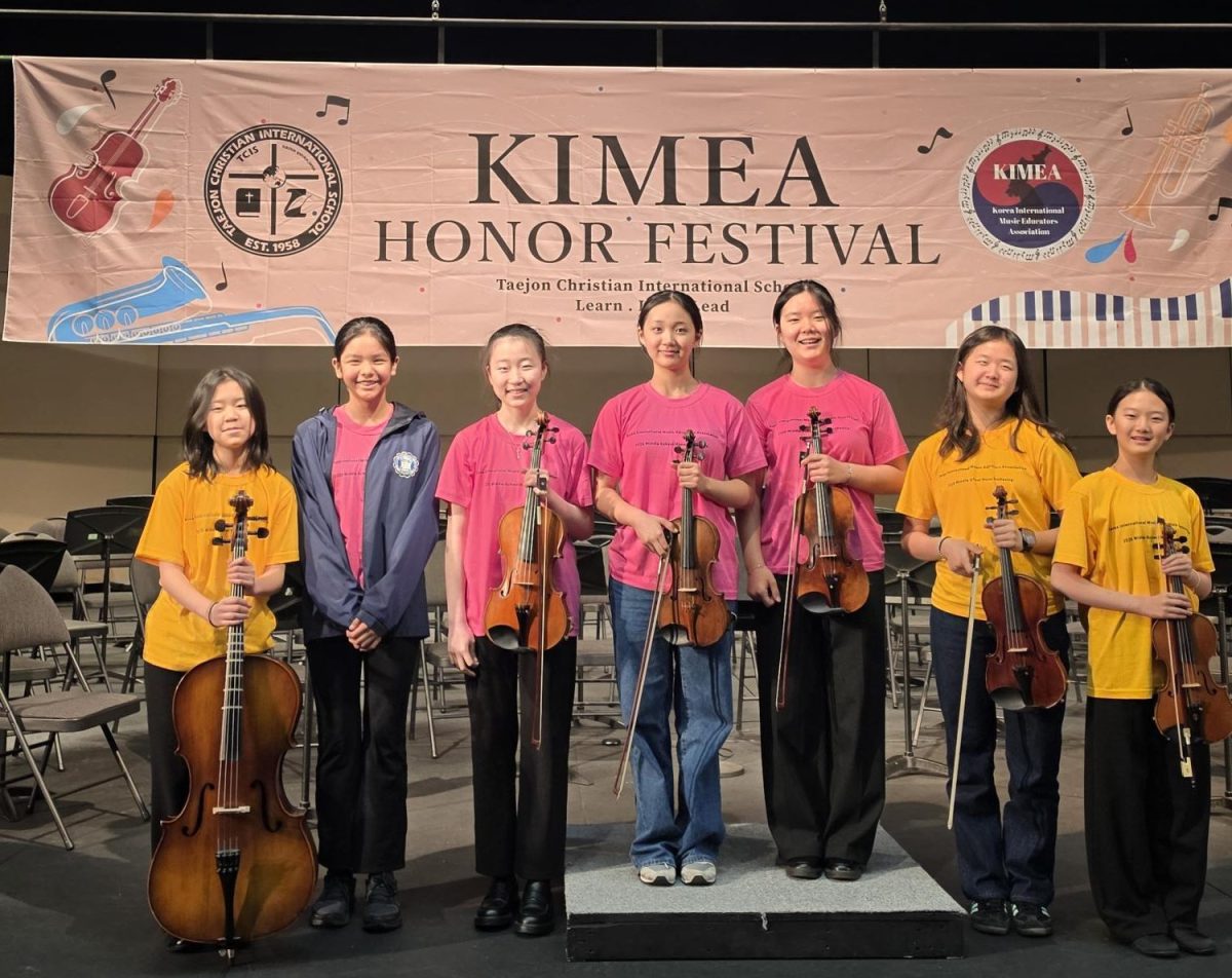 Student musicians celebrate following their performance, holding their instruments as the concert concludes. Their composed expressions and confident posture reflect the focus, dedication and preparation that shaped their achievement. Photo courtesy of Mr. Hutchings. 