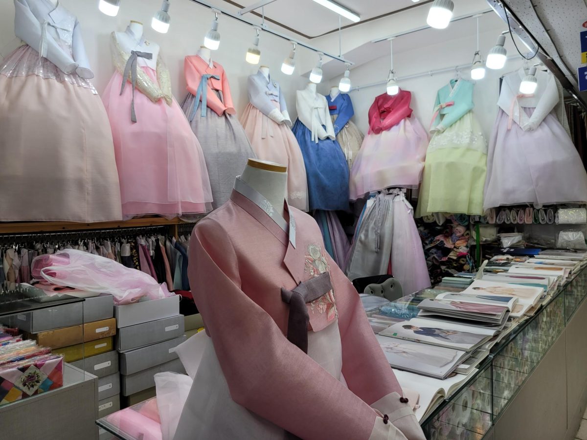 Traditional hanbok shops flaunt their exquisite designs, weaving together heritage and craftsmanship. Each piece of clothing reflects Korea’s elaborate history.