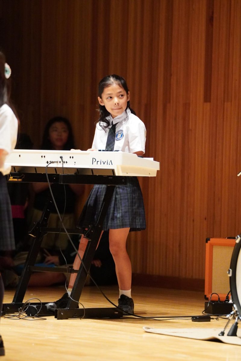 Third grader Shanvi Cha eases into her song with a calm introduction. The delicate notes create a quiet, attentive atmosphere throughout the gymnasium.